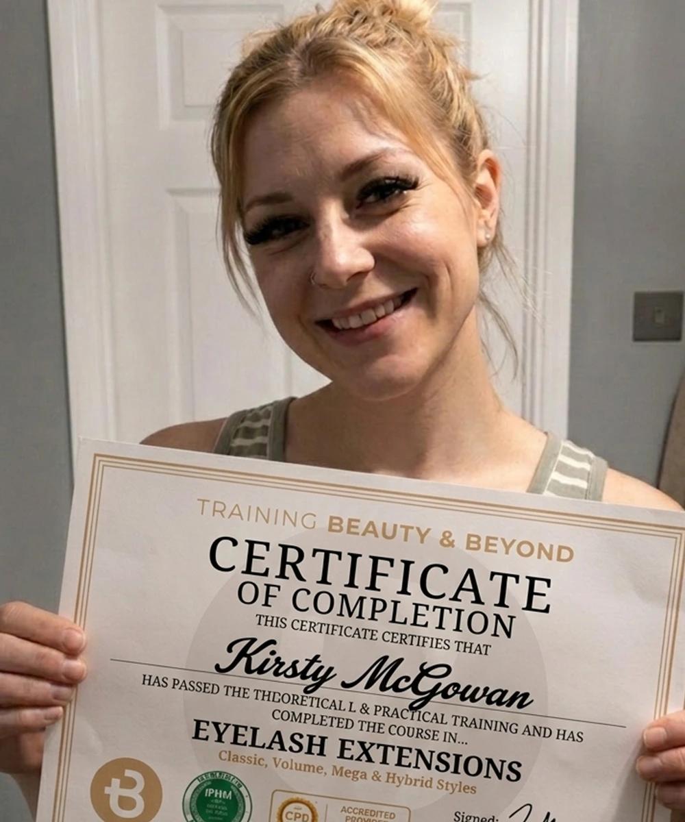 Student Kirsty holding her eyelash extension certificate