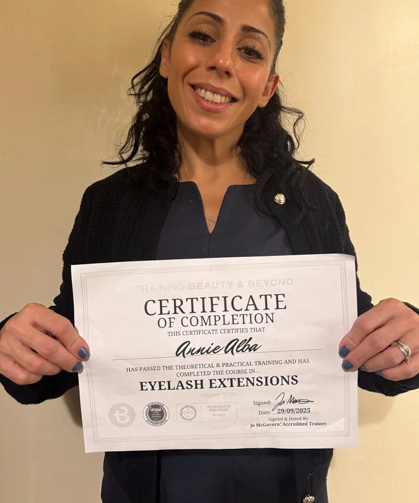 Student Annie Holding her Accredited Eyelash Extension Certificate