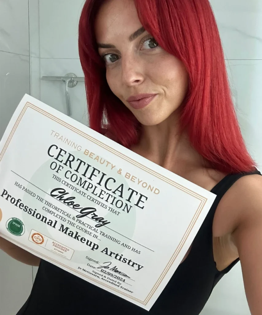 Student Chloe holding her Accredited Makeup Certificate