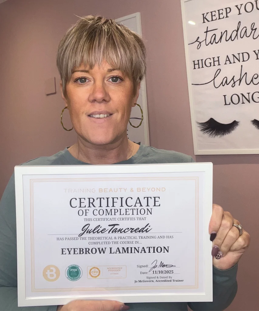 Student Jana Holding her Accredited Nail Technology Certificate