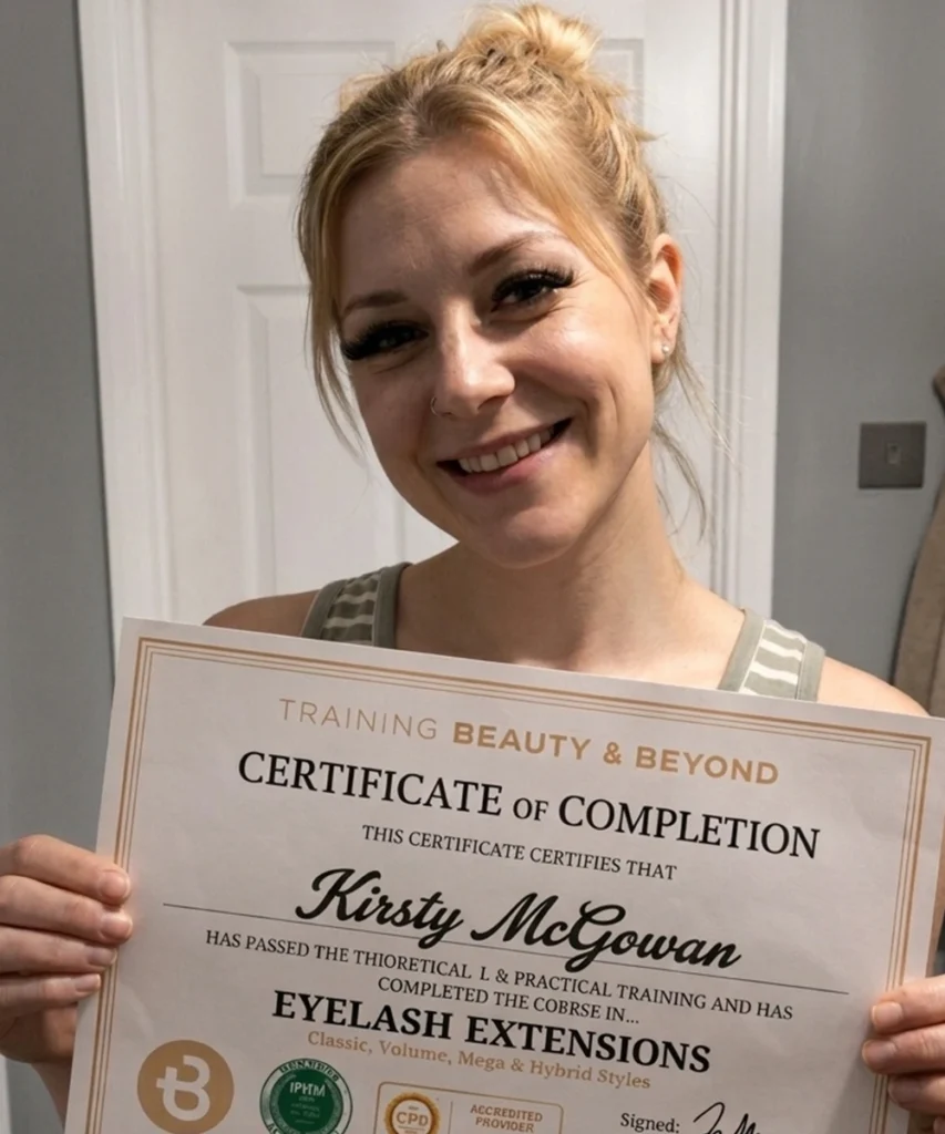 Student Kirsty holding her eyelash extension certificate